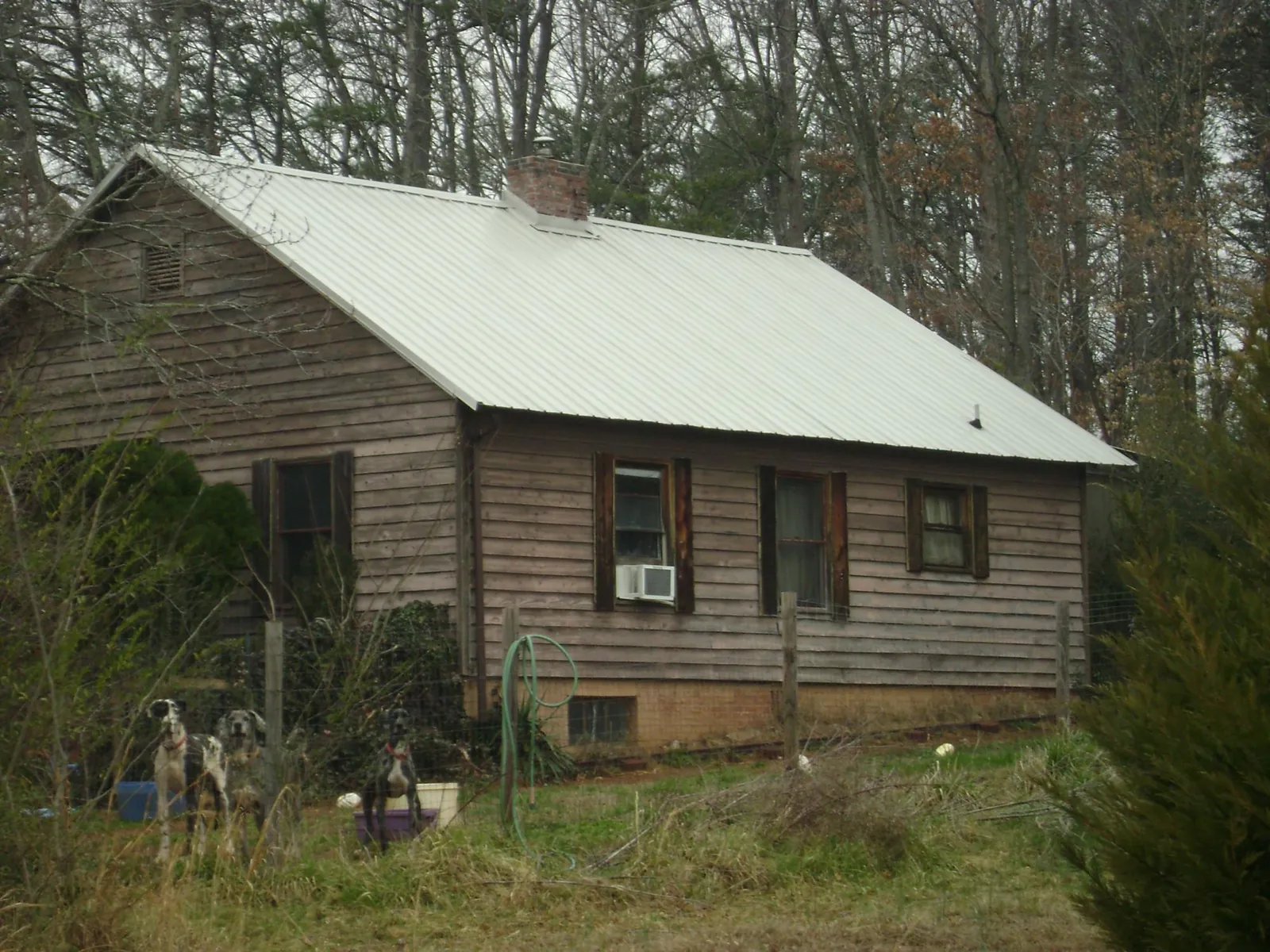 White metal roof on an old wood sided farmhouse, from a Metal Roof Installation job in Northumberland